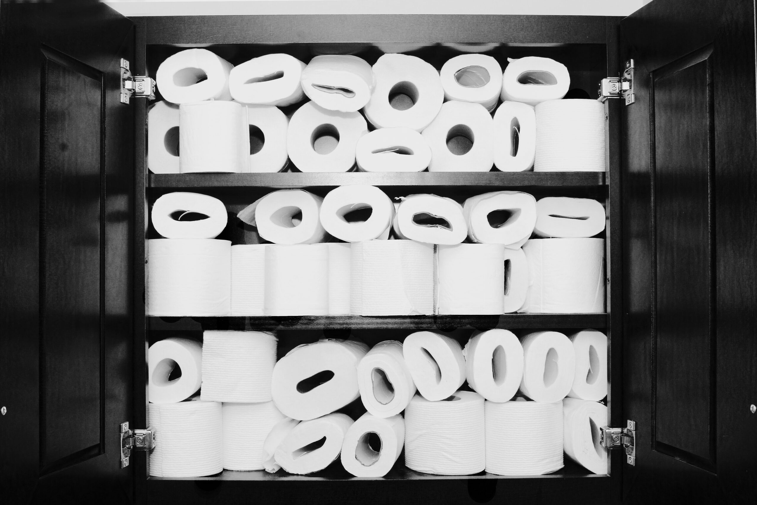 A tall, dense stack of toilet paper rolls
